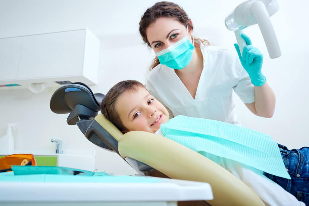 Beautiful kid boy smiling in dentist's chair during a visit to Children's Dentist O'Fallon